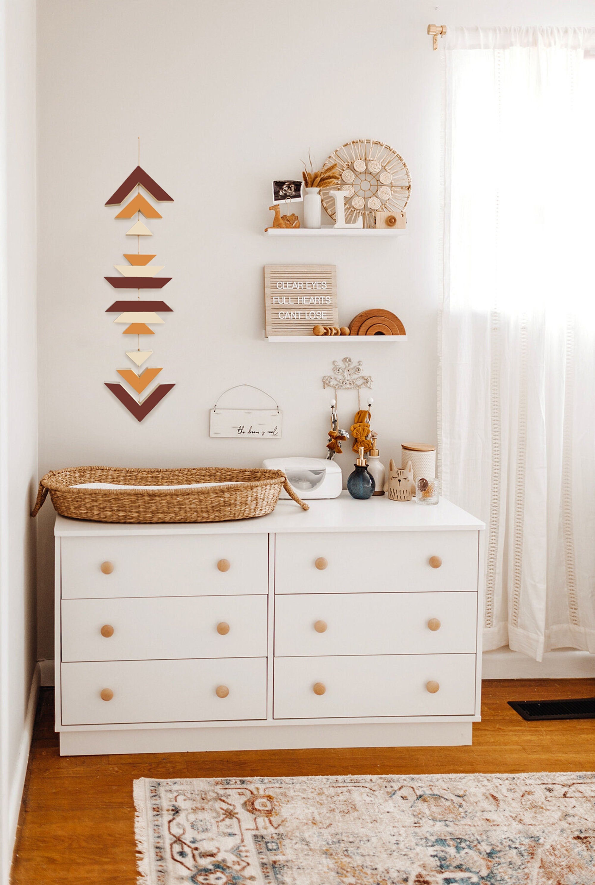 A beautiful cinnamon wood wall hanging featuring geometric designs, connected with cream cotton cord, perfect for boho decor.