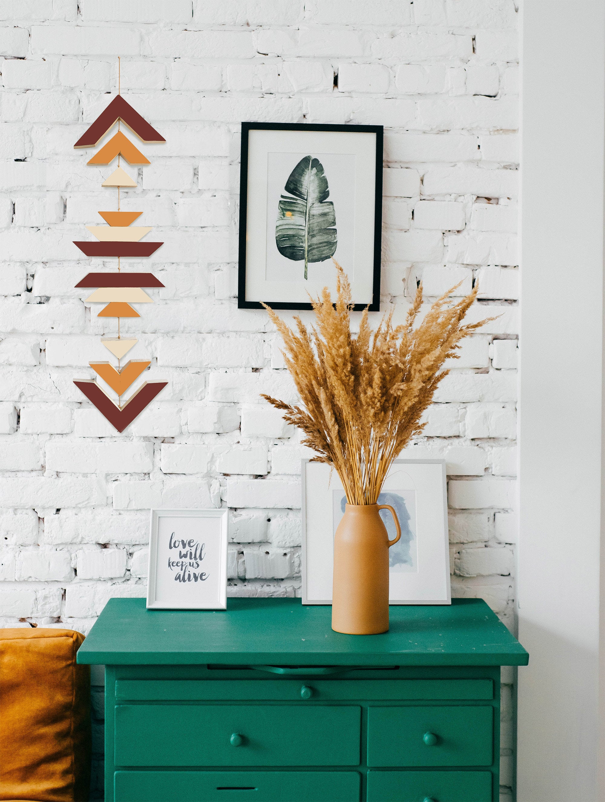 A beautiful cinnamon wood wall hanging featuring geometric designs, connected with cream cotton cord, perfect for boho decor.