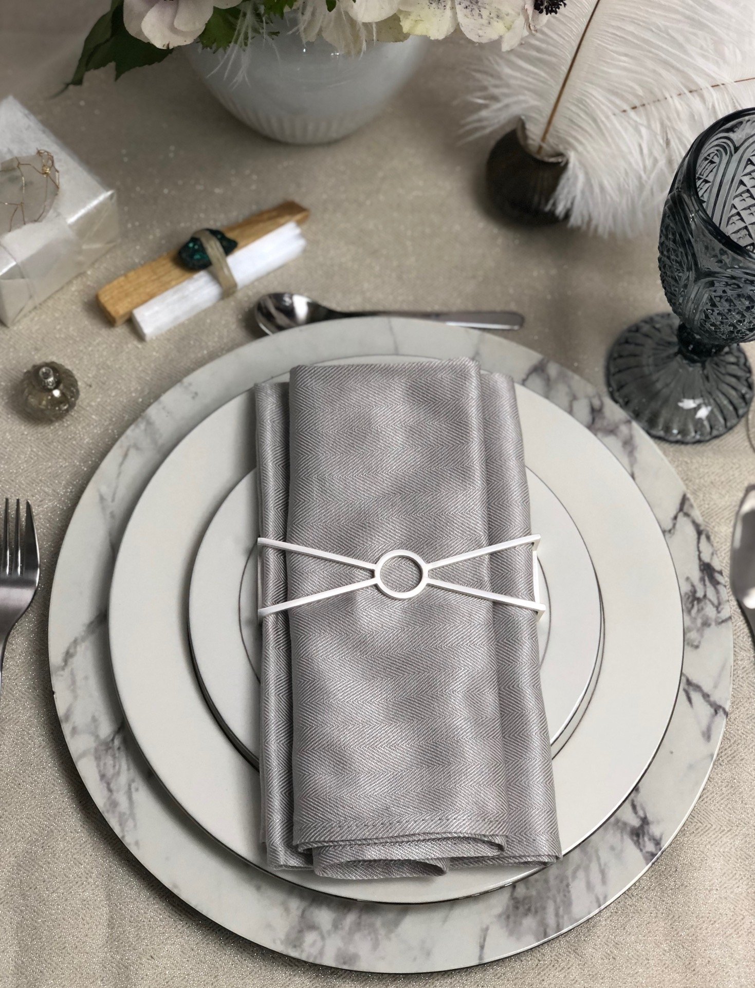 Circle X Napkin Wrap in Matte Silver, showcasing its sleek and modern design, perfect for elegant table settings.