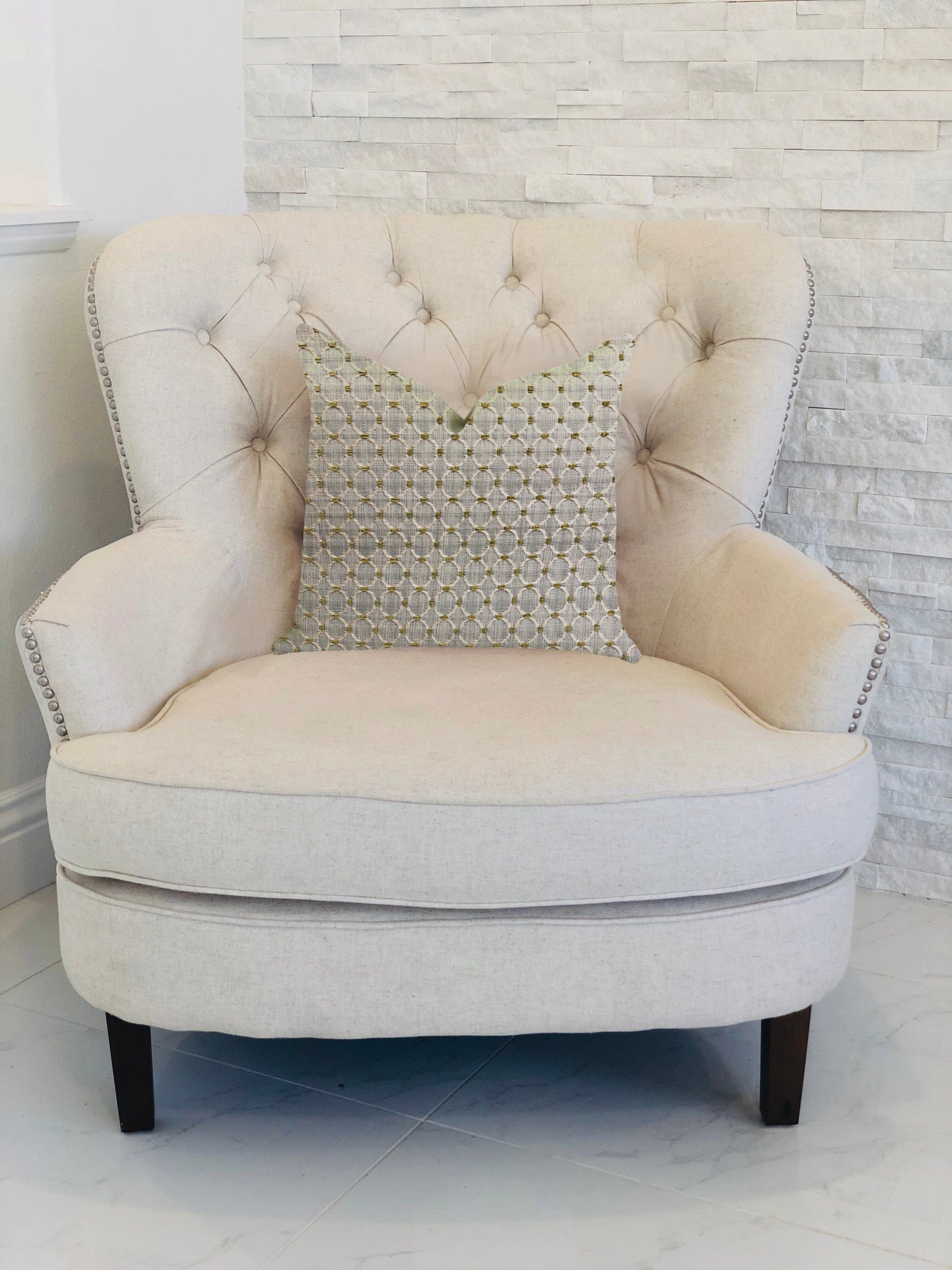 Circular ringed luxury throw pillow in gray and beige, showcasing a stylish design and invisible zipper closure.