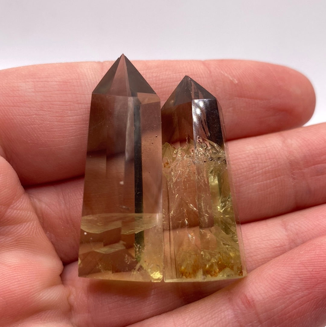 A polished citrine point measuring 1 inch, showcasing vibrant yellow to golden brown hues, symbolizing abundance and creativity.