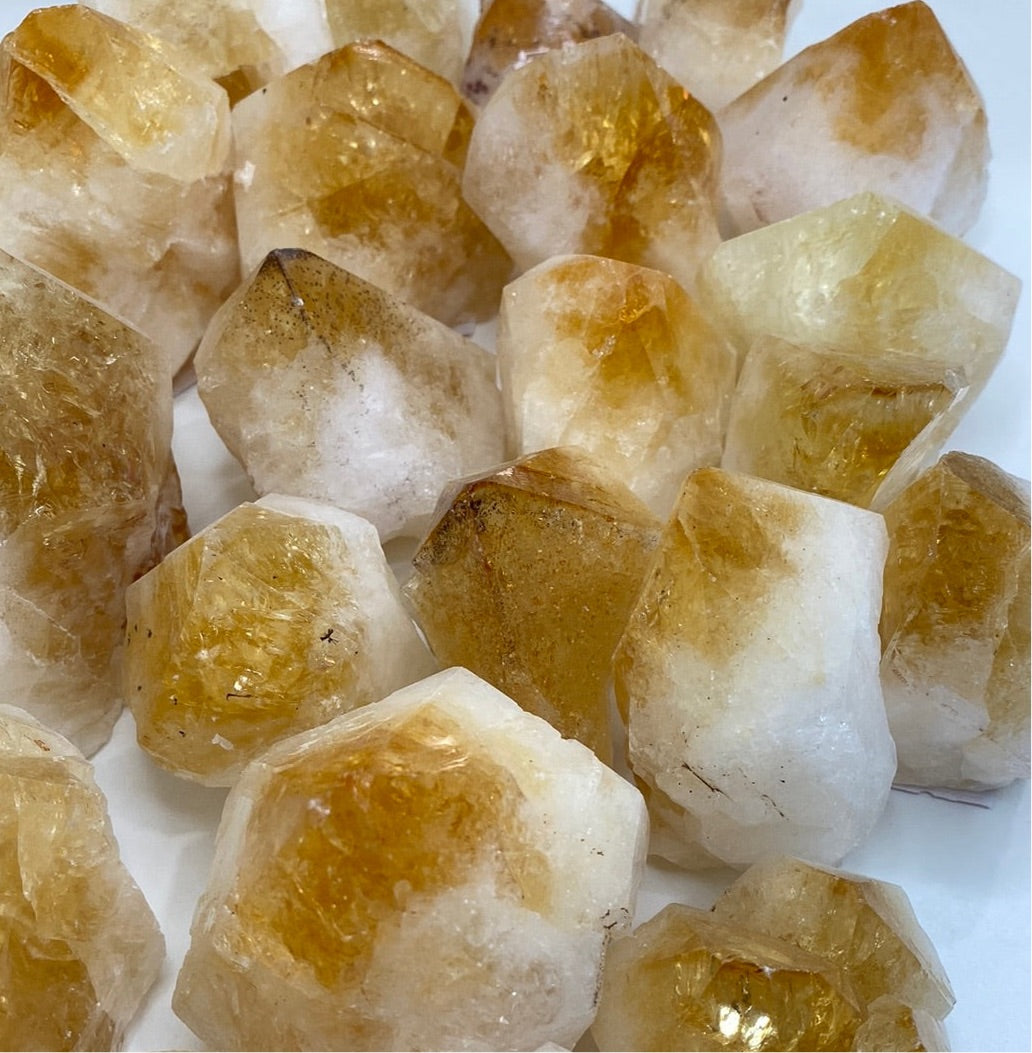 High-quality Citrine Cut Base Top Polished Points showcasing unique shapes and vibrant colors, perfect for energy healing.