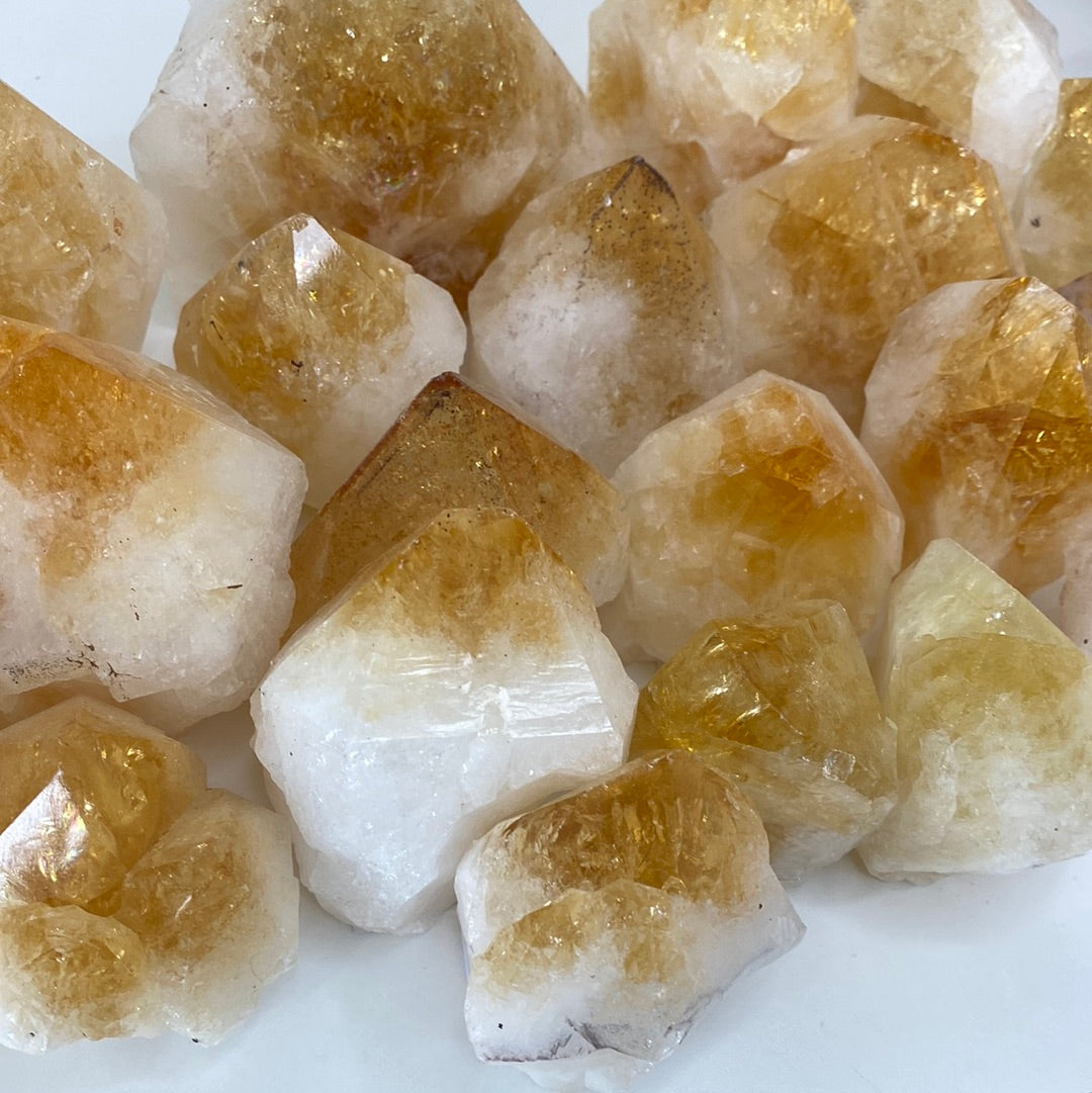 High-quality Citrine Cut Base Top Polished Points showcasing unique shapes and vibrant colors, perfect for energy healing.