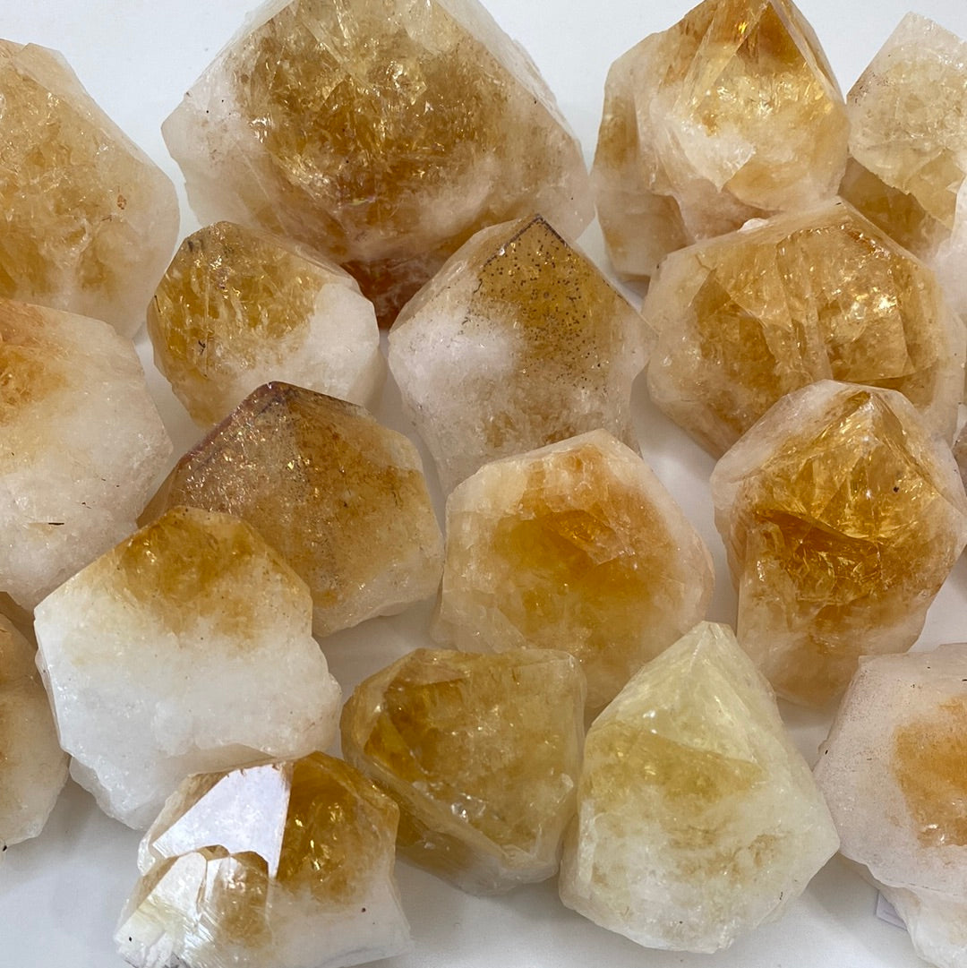 High-quality Citrine Cut Base Top Polished Points showcasing unique shapes and vibrant colors, perfect for energy healing.