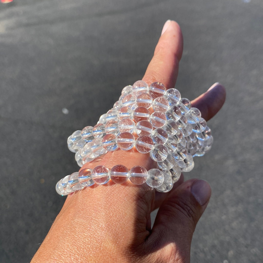 A stunning 8mm Clear Quartz Bracelet showcasing clear, polished beads that radiate healing energy.