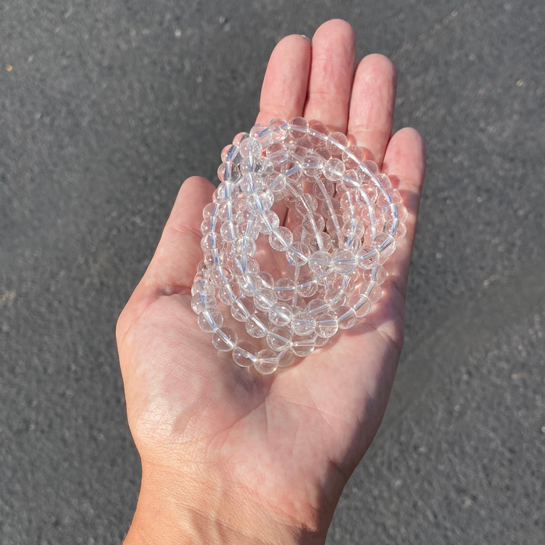 A stunning 8mm Clear Quartz Bracelet showcasing clear, polished beads that radiate healing energy.