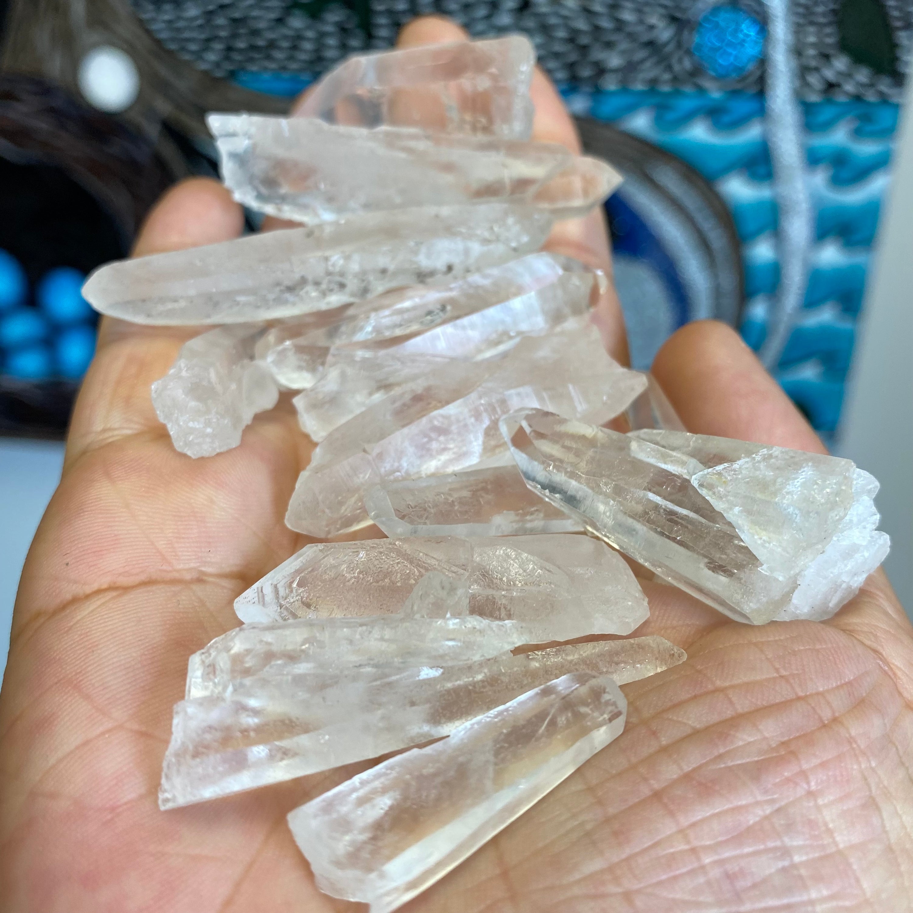 A collection of Clear Quartz Laser Points, showcasing their unique shapes and laser-like ends, ideal for energy work and crystal grids.