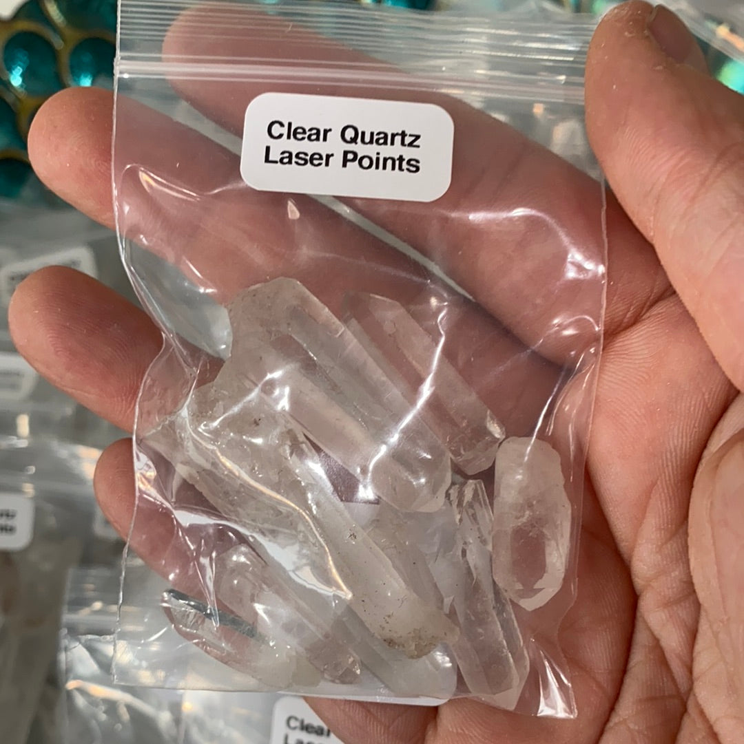 A collection of Clear Quartz Laser Points, showcasing their unique shapes and laser-like ends, ideal for energy work and crystal grids.