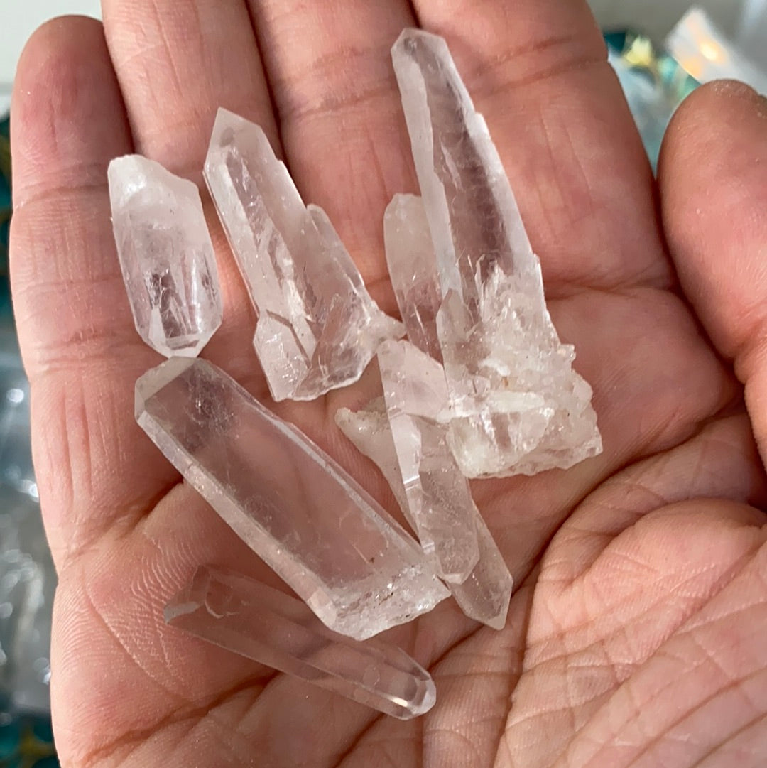 A collection of Clear Quartz Laser Points, showcasing their unique shapes and laser-like ends, ideal for energy work and crystal grids.