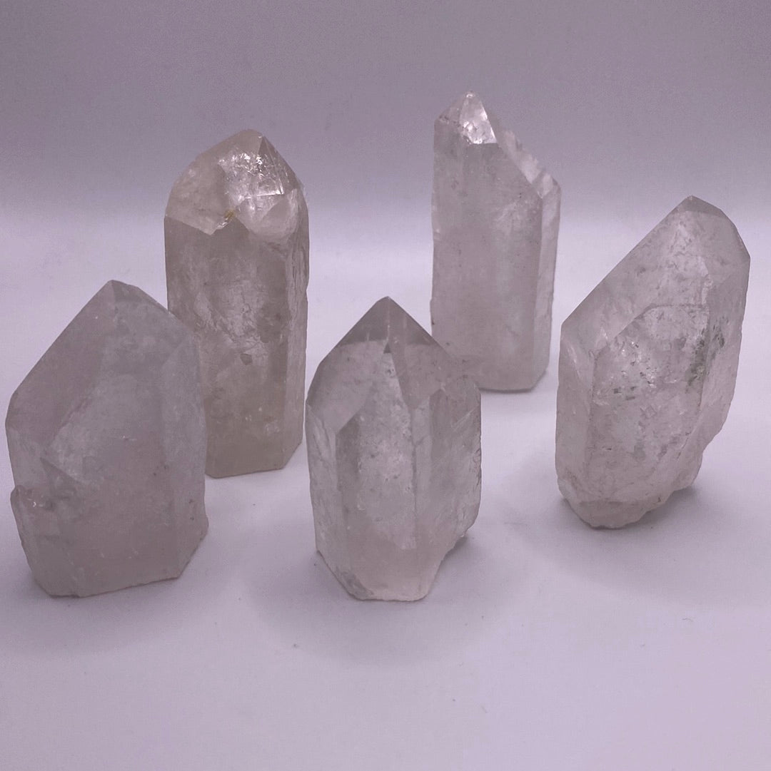 A clear quartz point with a cut base, showcasing its natural clarity and beauty, ideal for meditation and energy work.