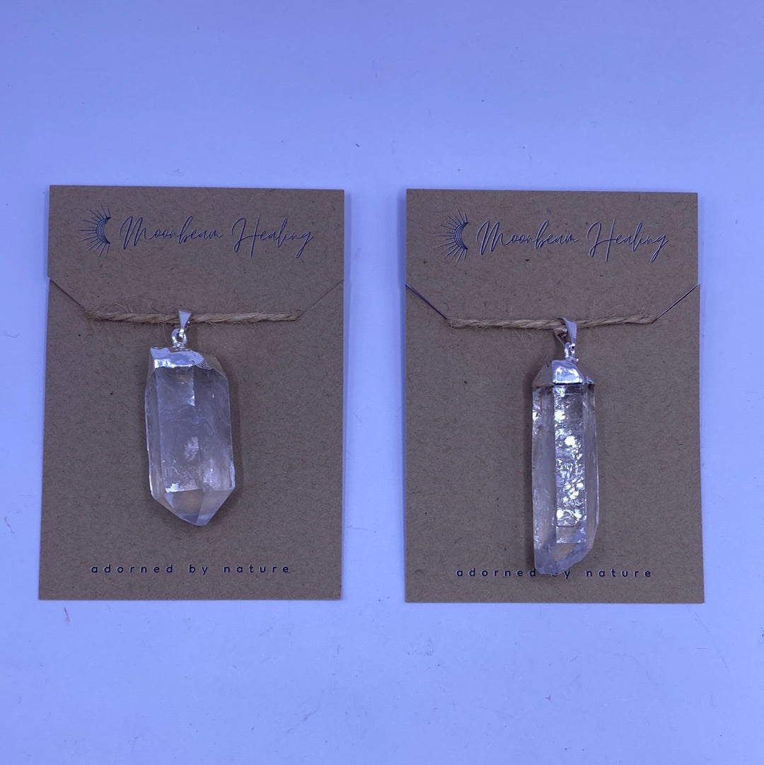 A stunning Clear Quartz Rough Cut Pendant with a silver electro-plated finish, showcasing its natural beauty and unique rough texture.