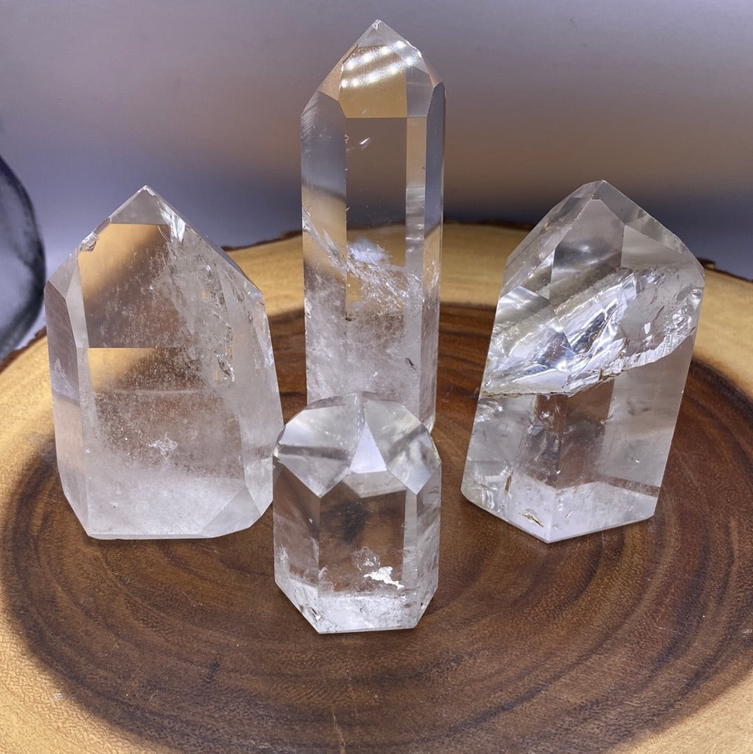 A beautifully polished Clear Quartz Tower from Brazil, showcasing its smooth surface and reflective facets, radiating clarity and energy.