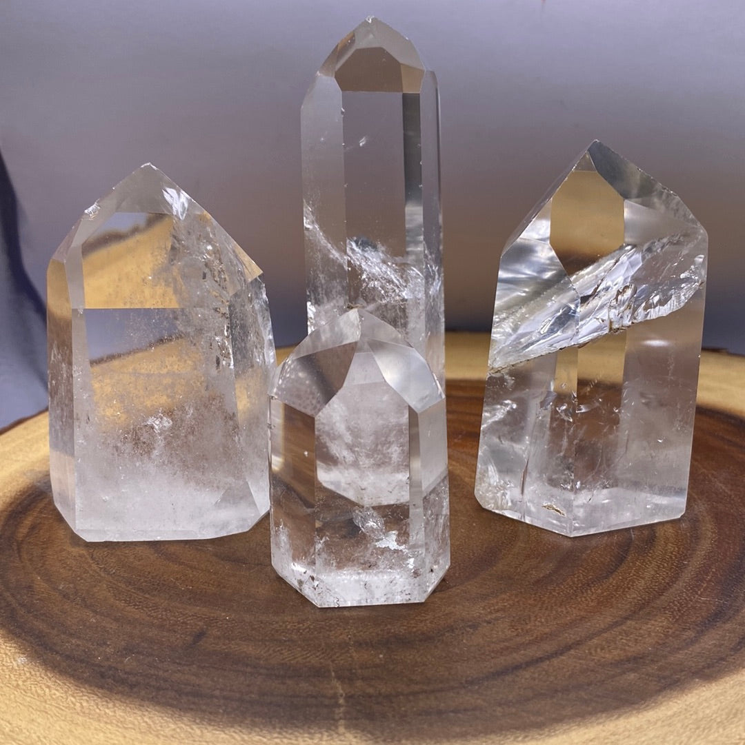 A beautifully polished Clear Quartz Tower from Brazil, showcasing its smooth surface and reflective facets, radiating clarity and energy.