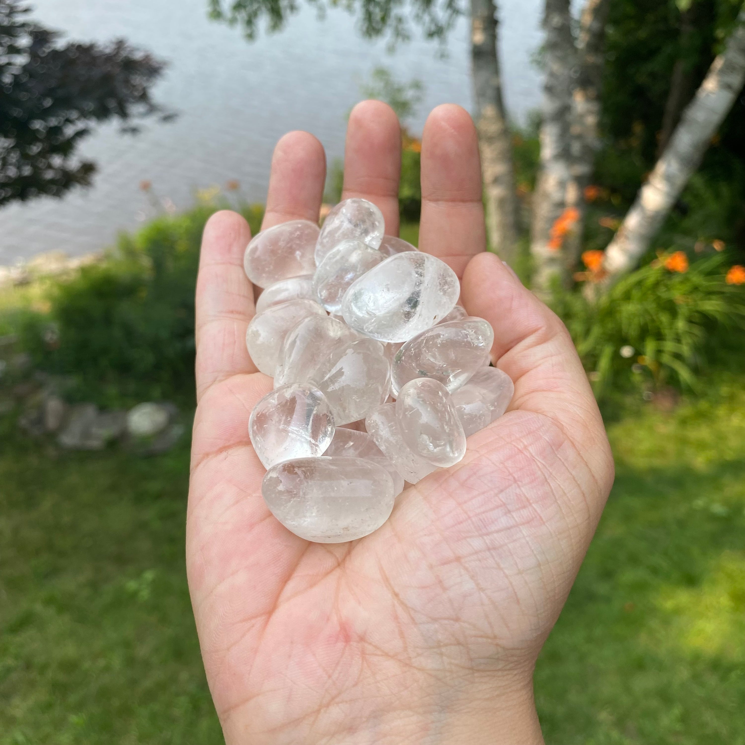 A collection of Clear Quartz Tumbled Crystal Stones, showcasing their unique shapes and sizes, perfect for healing and meditation.