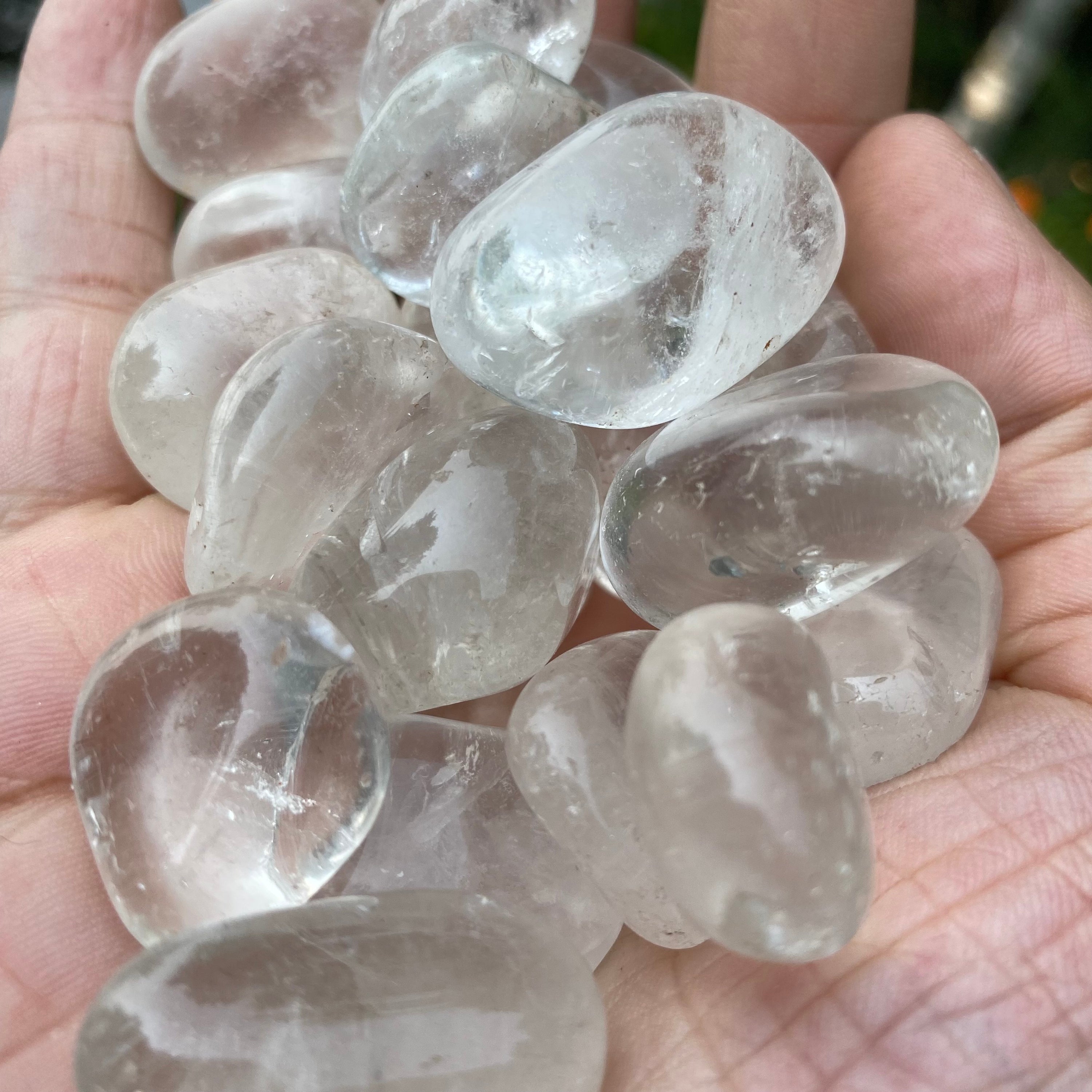 A collection of Clear Quartz Tumbled Crystal Stones, showcasing their unique shapes and sizes, perfect for healing and meditation.