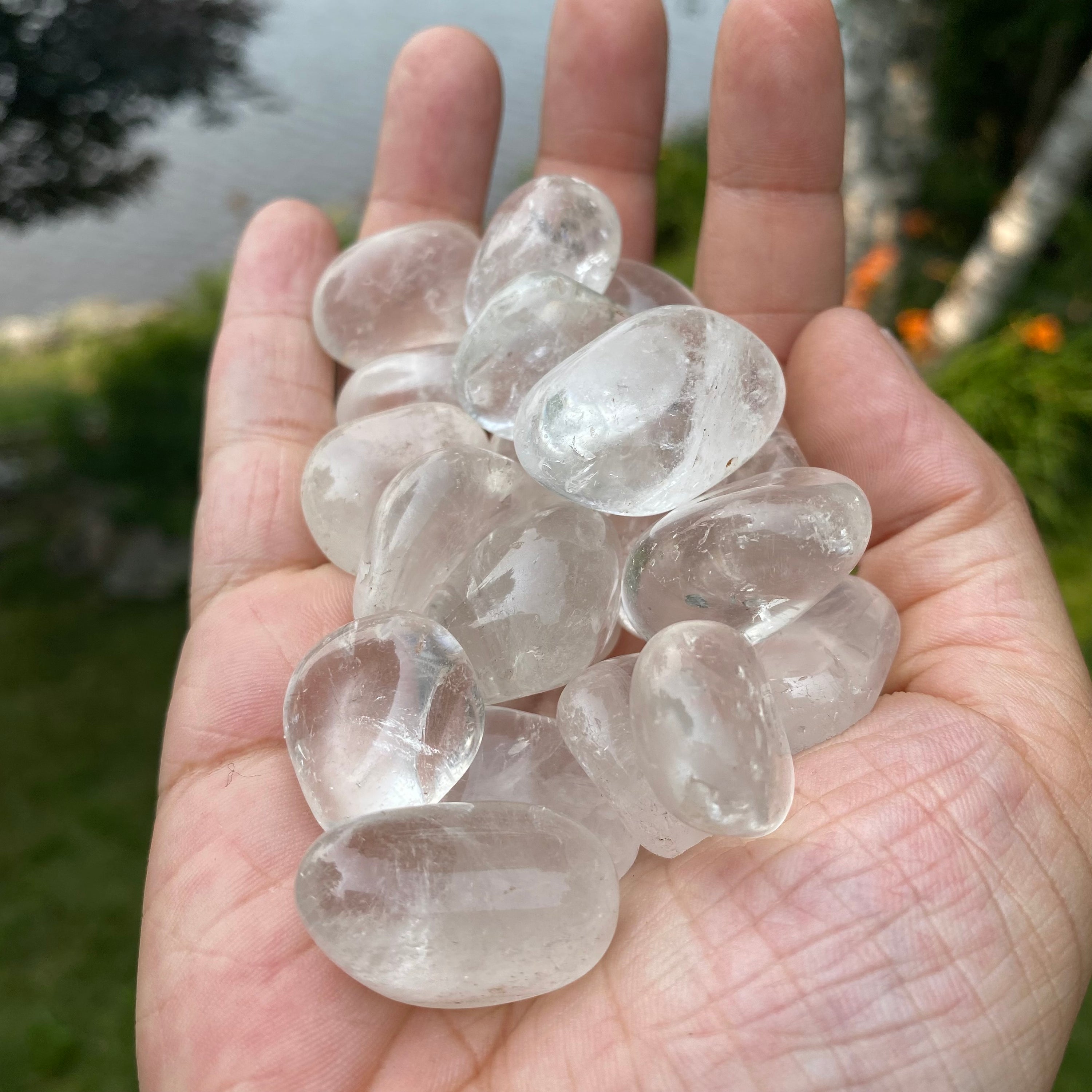 A collection of Clear Quartz Tumbled Crystal Stones, showcasing their unique shapes and sizes, perfect for healing and meditation.