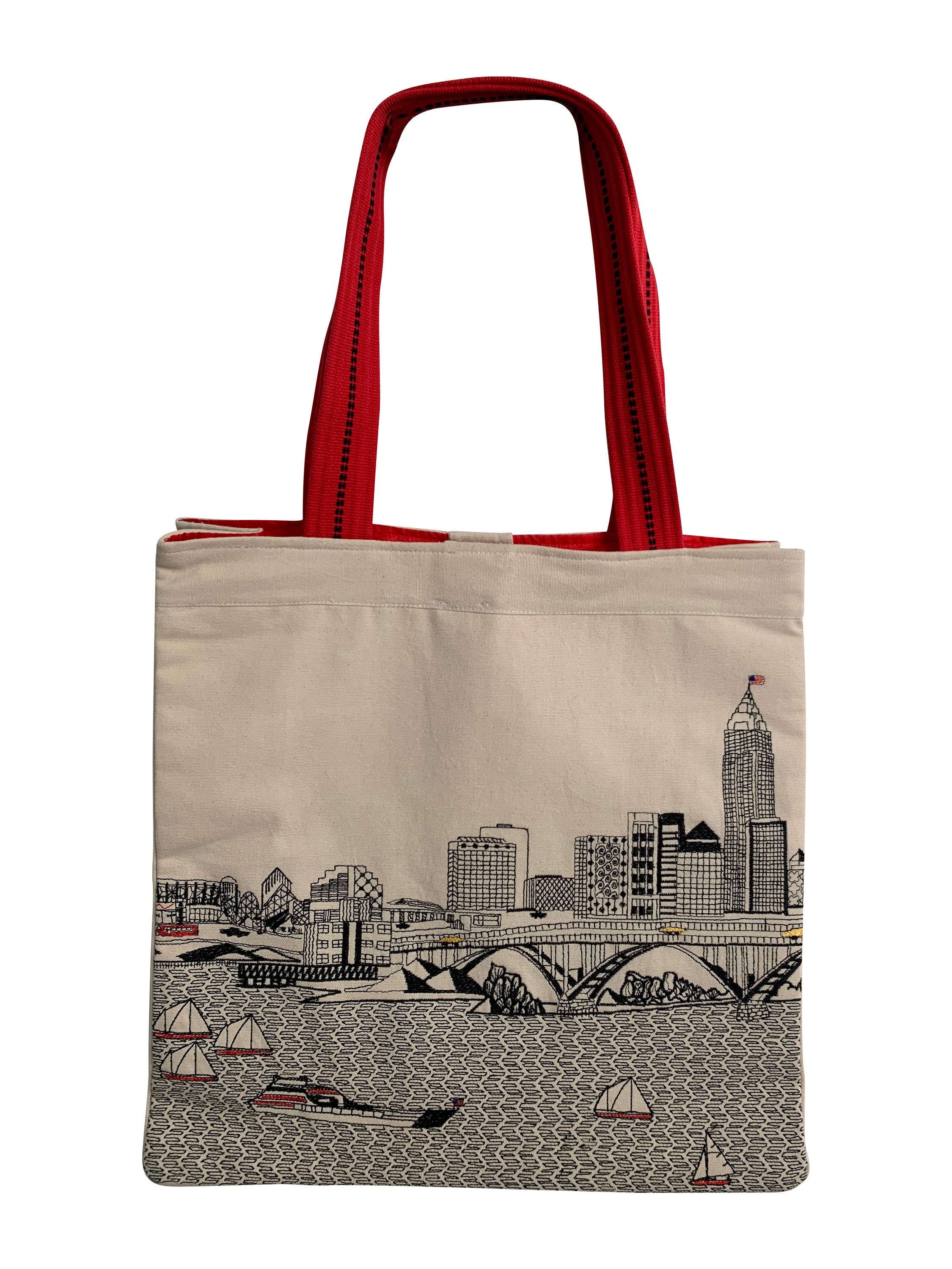 Cleveland Tote Bag featuring an embroidered skyline design on cream and black cotton canvas with red waterproof lining and ribbed straps.