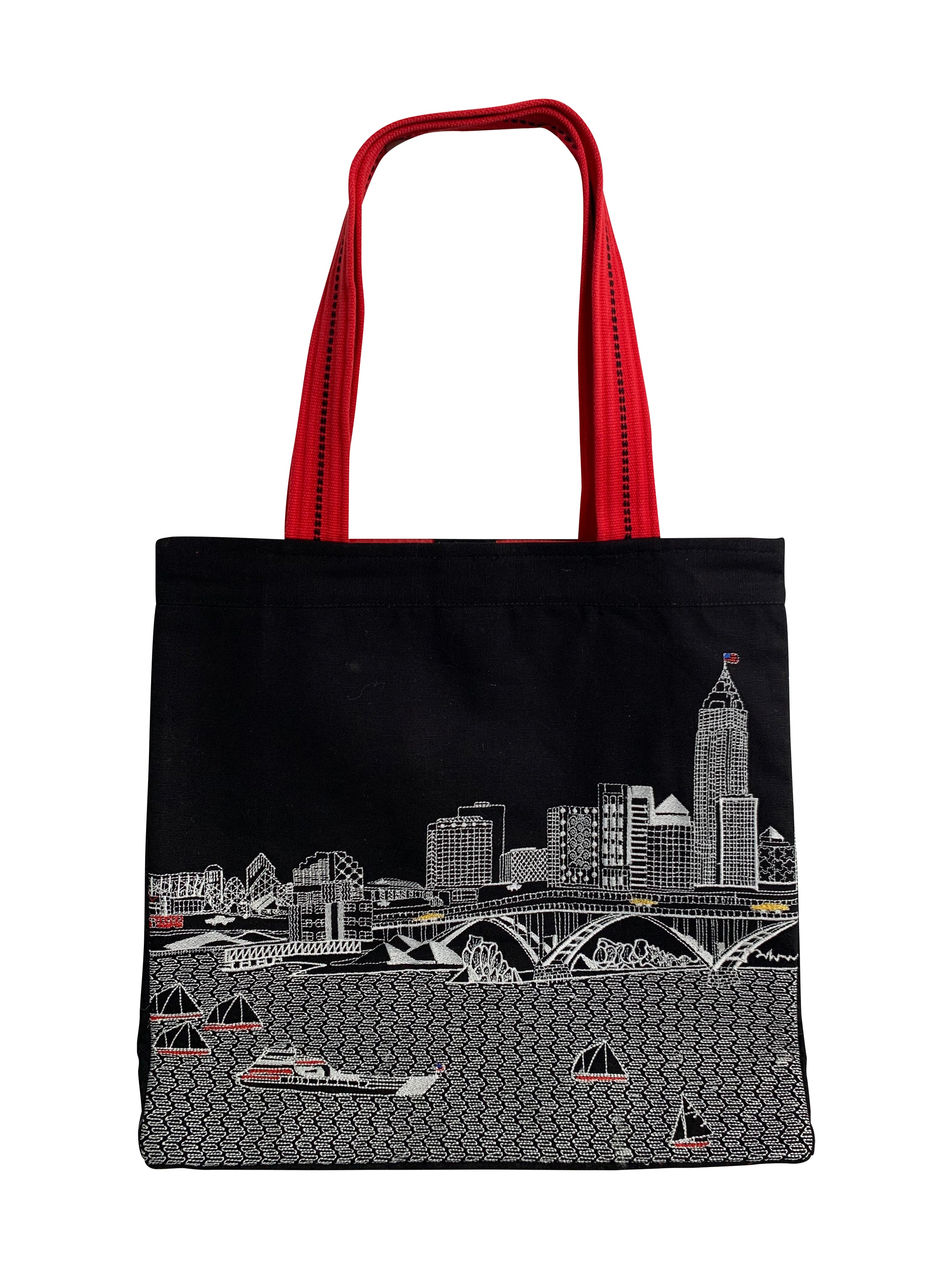 Cleveland Tote Bag featuring an embroidered skyline design on cream and black cotton canvas with red waterproof lining and ribbed straps.