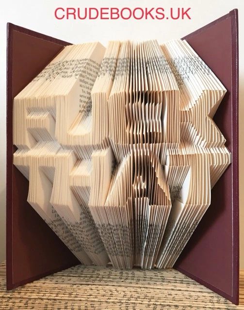 Hand-folded book art made from reclaimed vintage books, showcasing unique designs and colors.