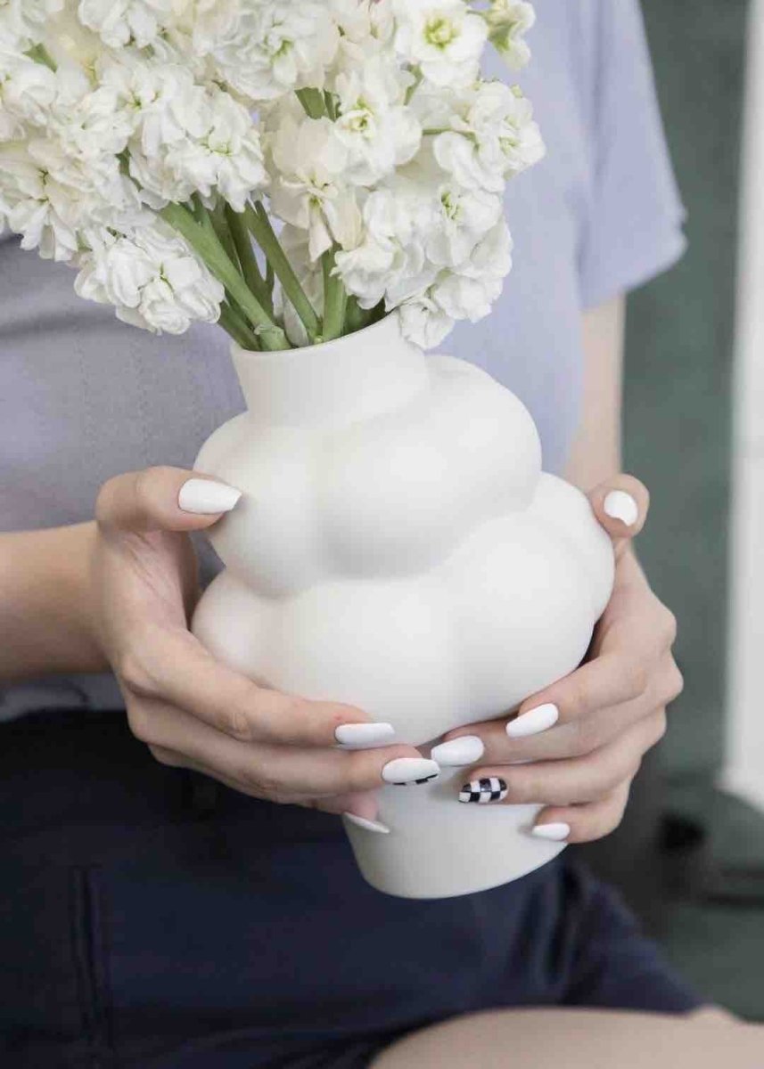 A whimsical ceramic flower vase shaped like a cloud, showcasing its unique design and smooth finish.