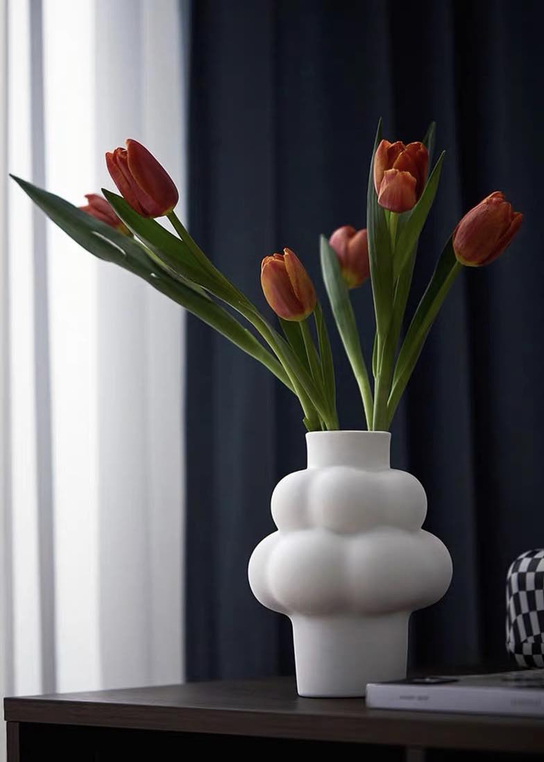 A whimsical ceramic flower vase shaped like a cloud, showcasing its unique design and smooth finish.