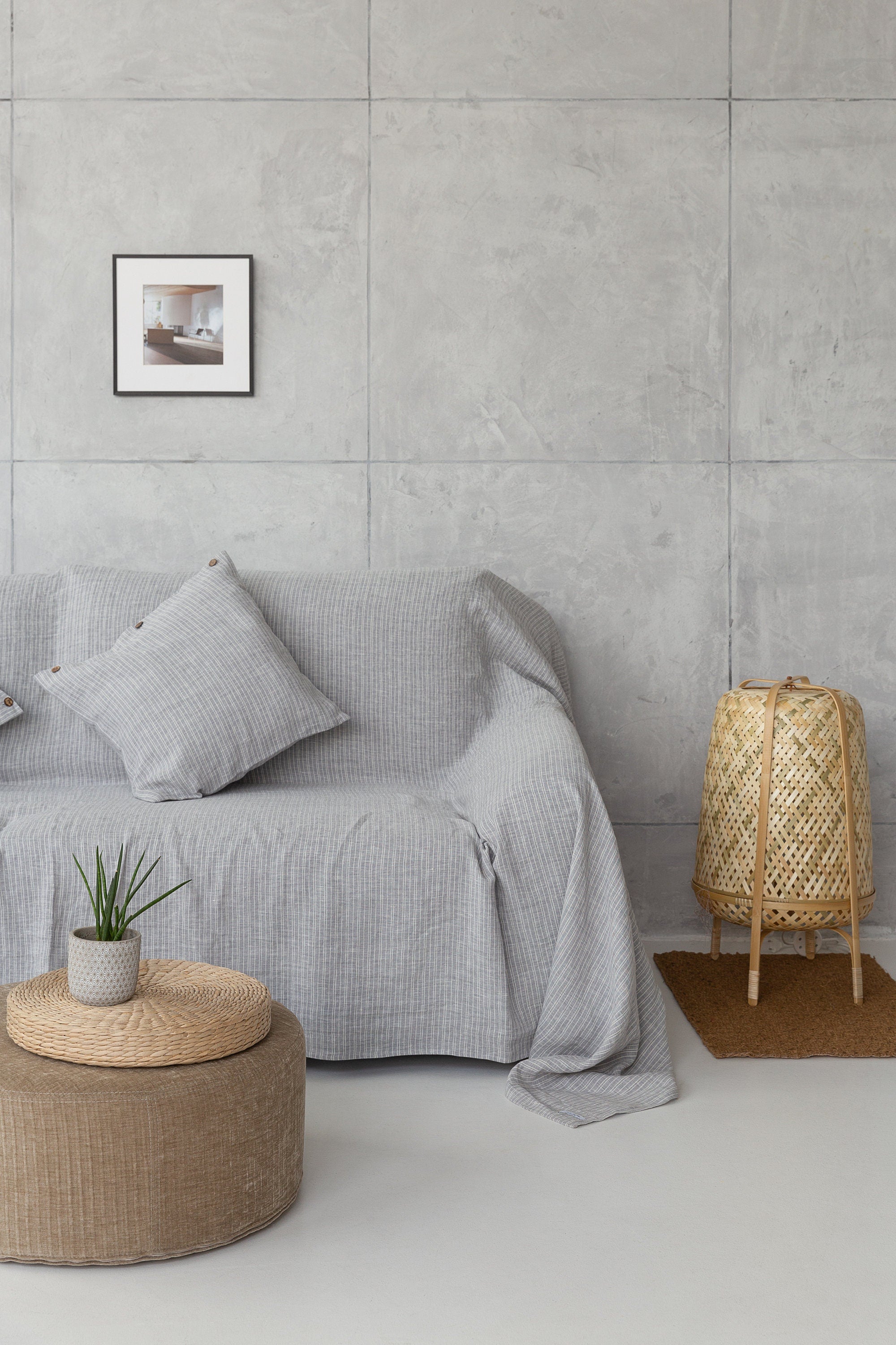 Cloudy Grey Stripe linen couch cover draped elegantly over a sofa, showcasing its soft texture and stylish design.