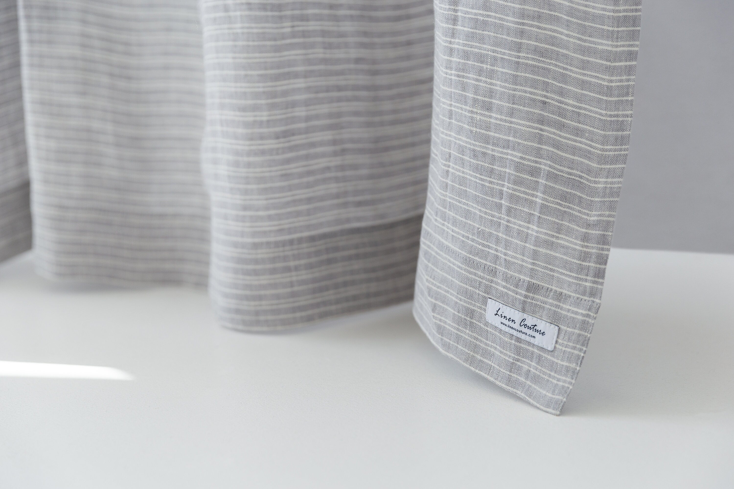 Cloudy Grey Stripe linen curtain with pleating tape and crown, showcasing elegant design and natural fabric texture.