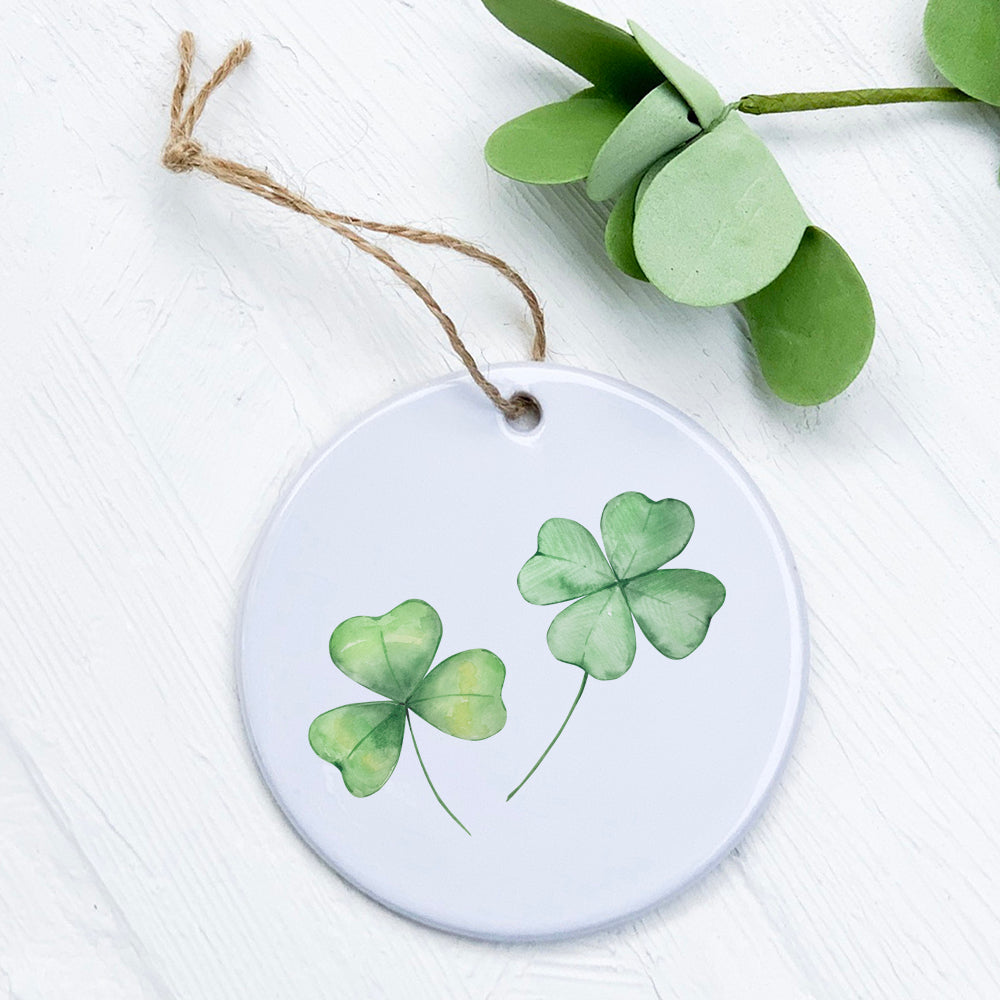 Clover Pair Ornament made of high-quality porcelain, featuring original designs with a smooth gloss finish, measuring 2.75 inches in diameter.