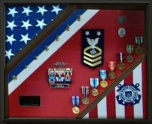 Coast Guard Flag Display featuring a black wood frame and Plexiglas cover, showcasing a USCG flag and medals.