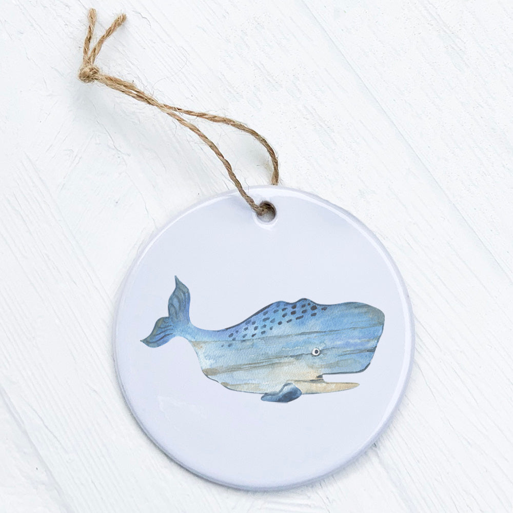 Coastal Wood Whale Ornament made of high-quality porcelain with a vibrant design, measuring 2.75 inches in diameter.