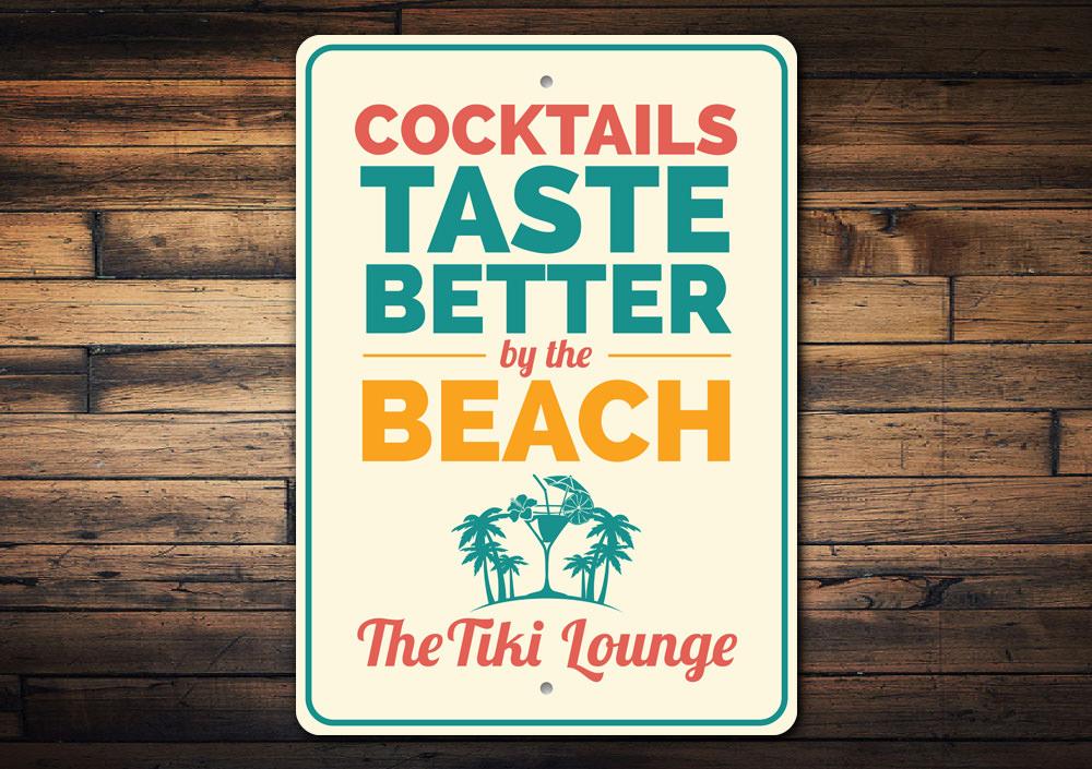 Cocktails Taste Better By The Beach Sign made of durable aluminum, featuring vibrant colors and a beach-themed design, perfect for coastal decor.