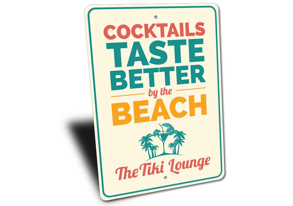 Cocktails Taste Better By The Beach Sign made of durable aluminum, featuring vibrant colors and a beach-themed design, perfect for coastal decor.