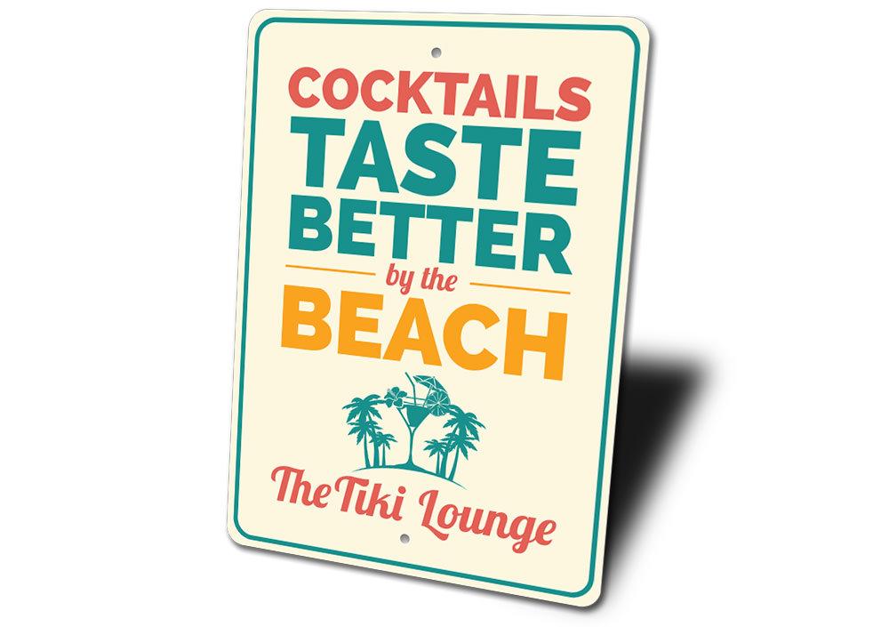 Cocktails Taste Better By The Beach Sign made of durable aluminum, featuring vibrant colors and a beach-themed design, perfect for coastal decor.