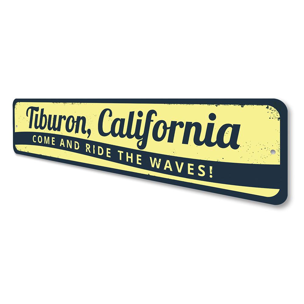 A decorative 'Come and Ride the Waves' sign made of aluminum, featuring beach-themed graphics and customizable text, perfect for coastal decor.