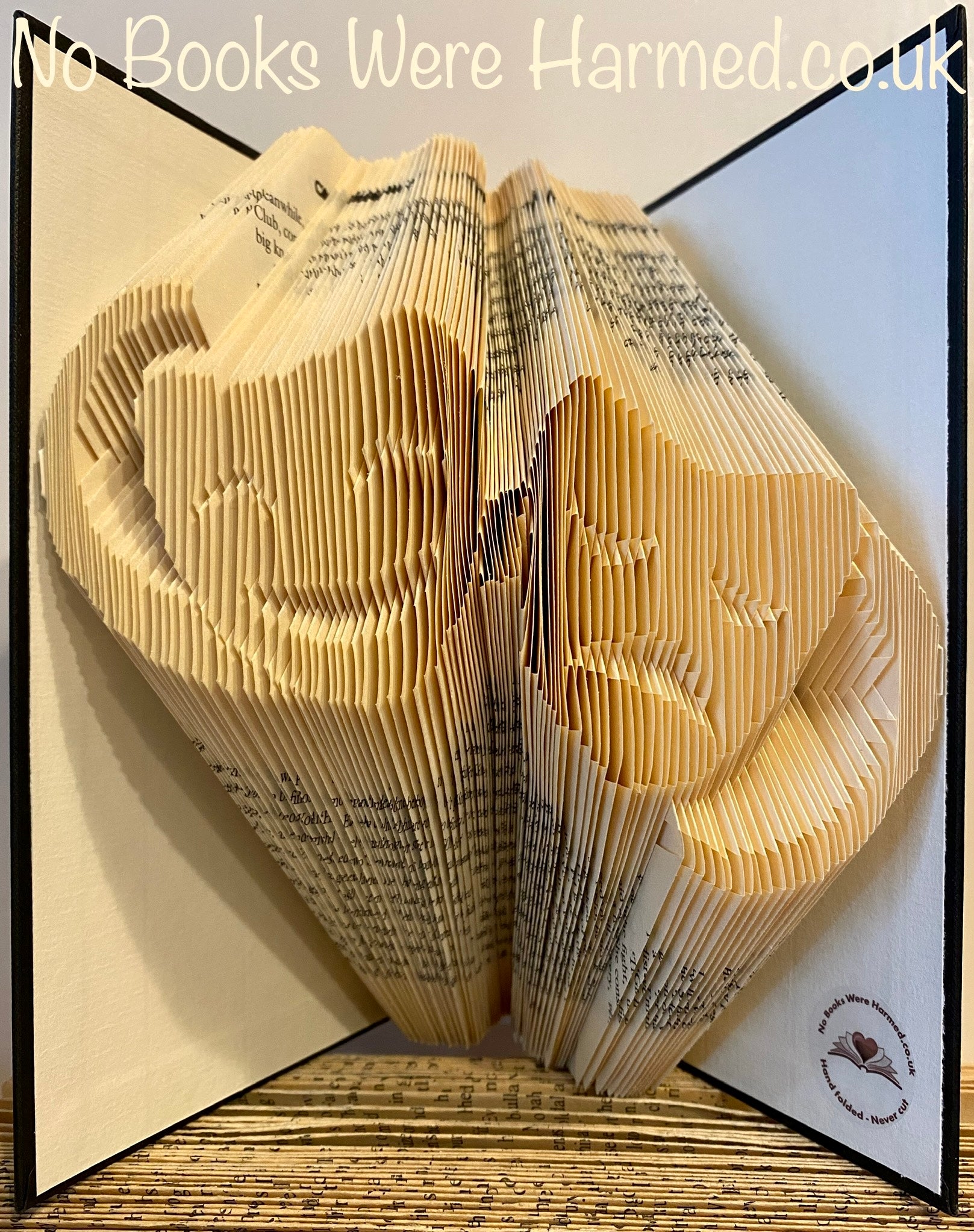 Handcrafted Comedy & Tragedy book art made from vintage pages, showcasing intricate folds and unique designs.