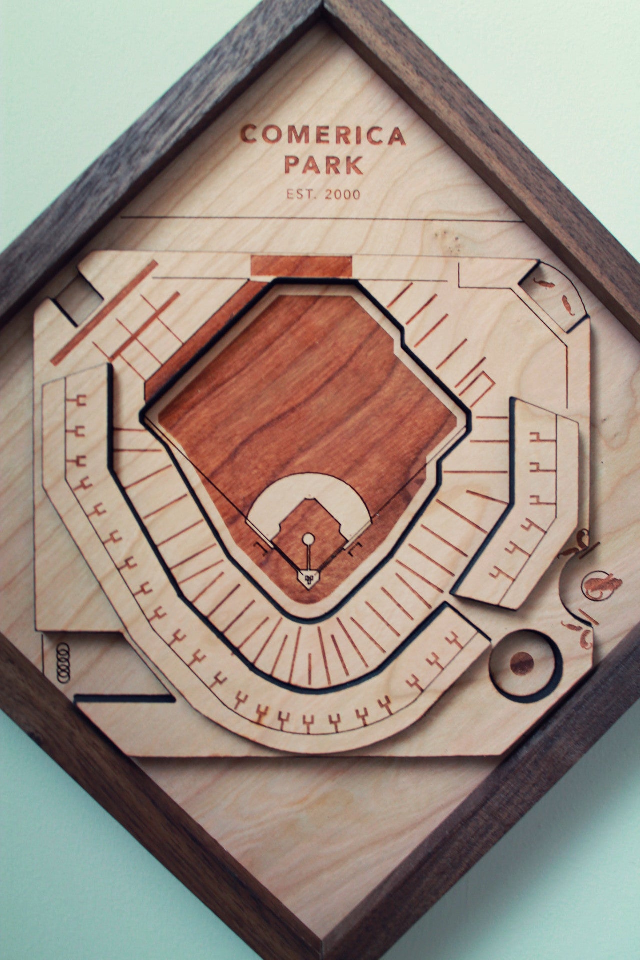 Handcrafted wooden representation of Comerica Park featuring tigers, ferris wheel, and merry-go-round, framed in black walnut.