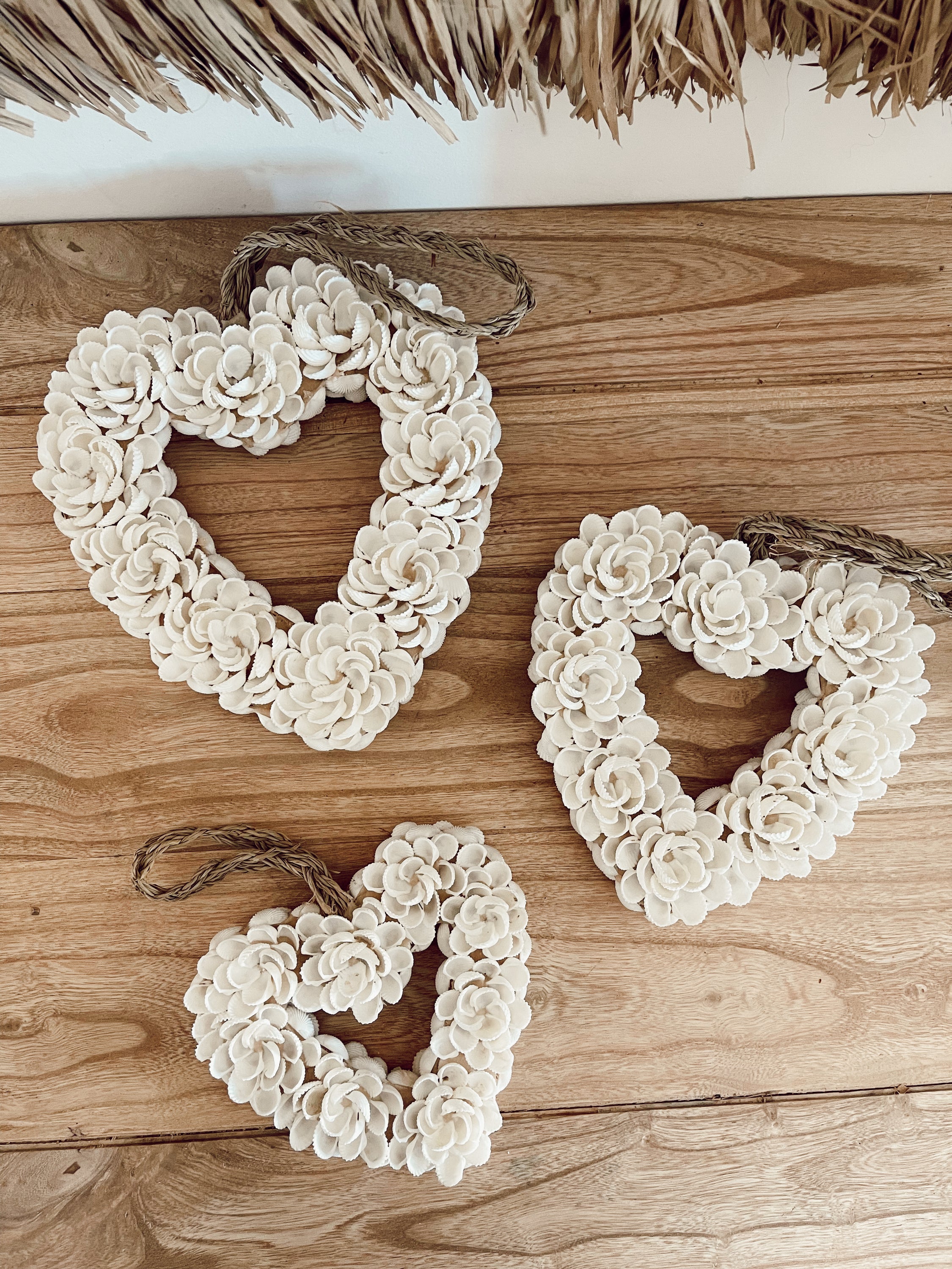 Handmade heart wall decoration made from natural shells, perfect for home decor.