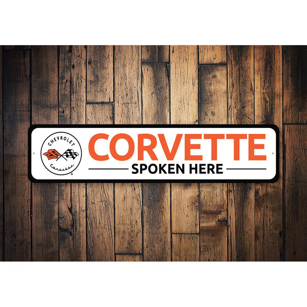 Corvette Spoken Here metal sign, featuring vibrant colors and a sleek design, perfect for car enthusiasts' decor.