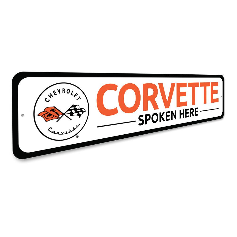 Corvette Spoken Here metal sign, featuring vibrant colors and a sleek design, perfect for car enthusiasts' decor.