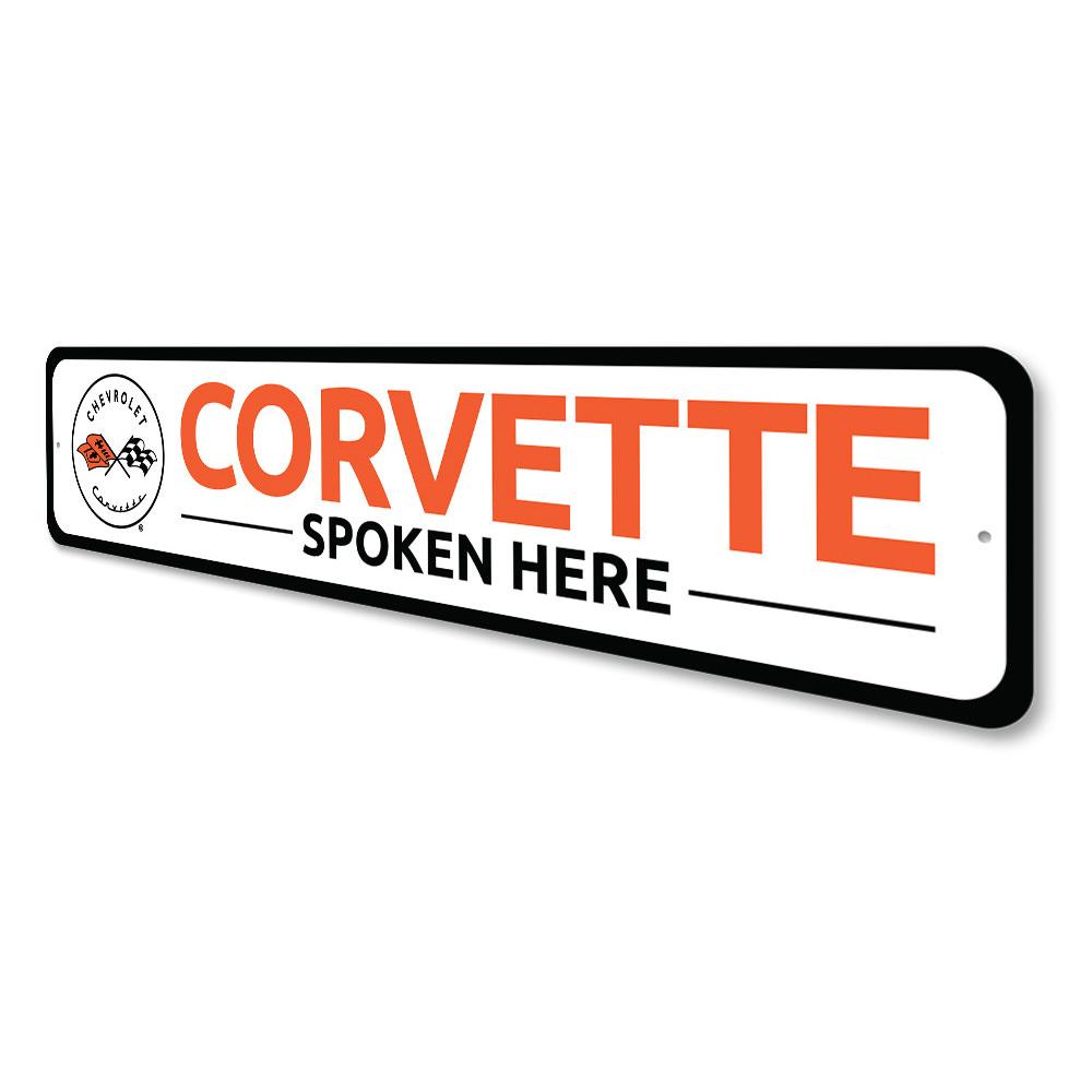 Corvette Spoken Here metal sign, featuring vibrant colors and a sleek design, perfect for car enthusiasts' decor.