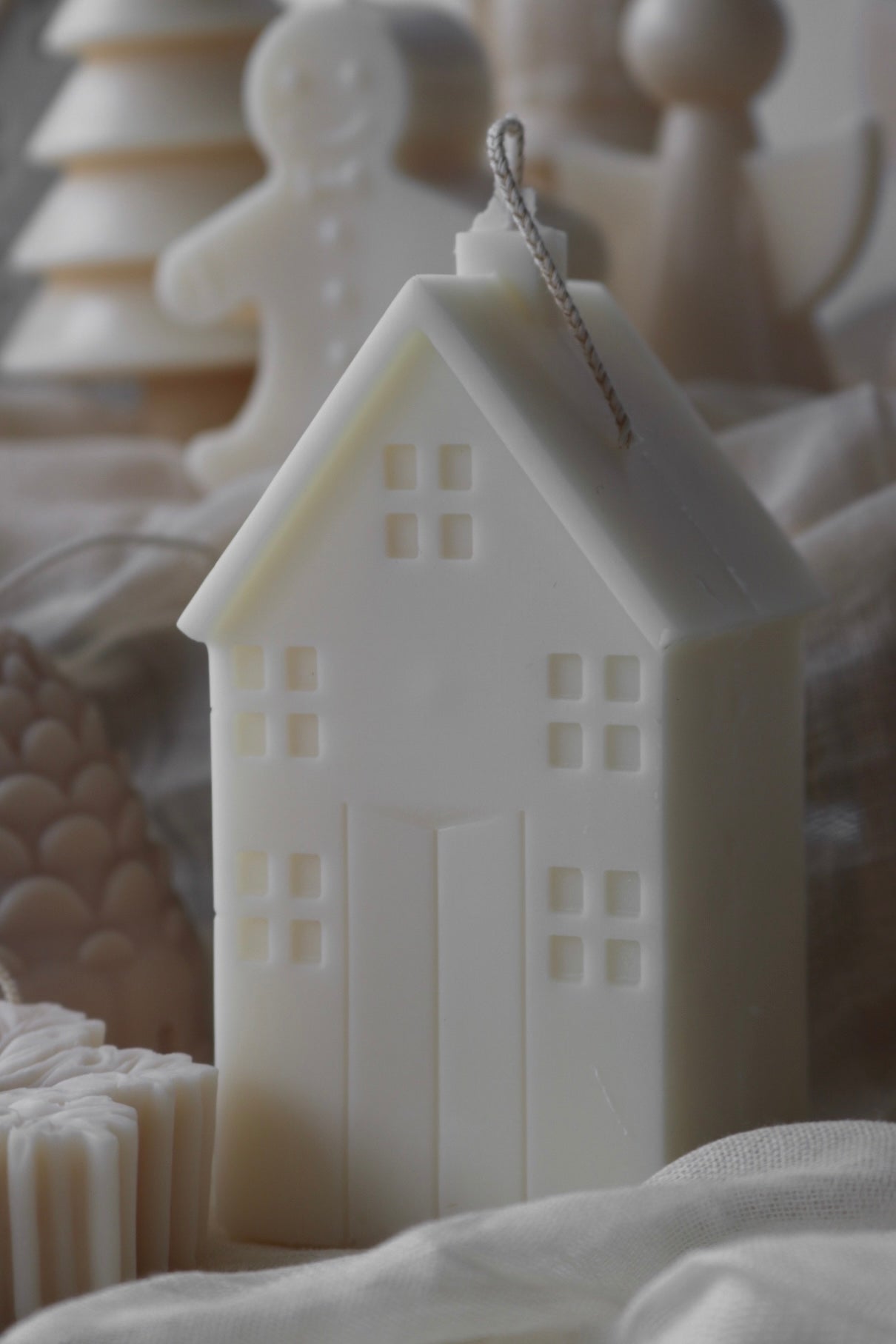 A beautifully sculptural Cosy House Candle made from soy wax blend, perfect for home decor, featuring a warm and elegant design.