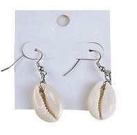 A pair of handmade cowrie shell earrings featuring natural colors ranging from white to beige, symbolizing protection and strength.