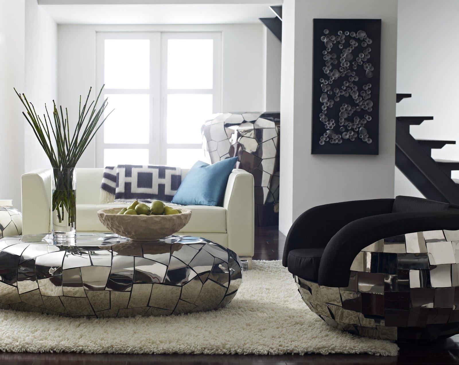 Crazy Cut Oblong Coffee Table with segmented surface in polished stainless steel, reflecting light and surroundings elegantly.