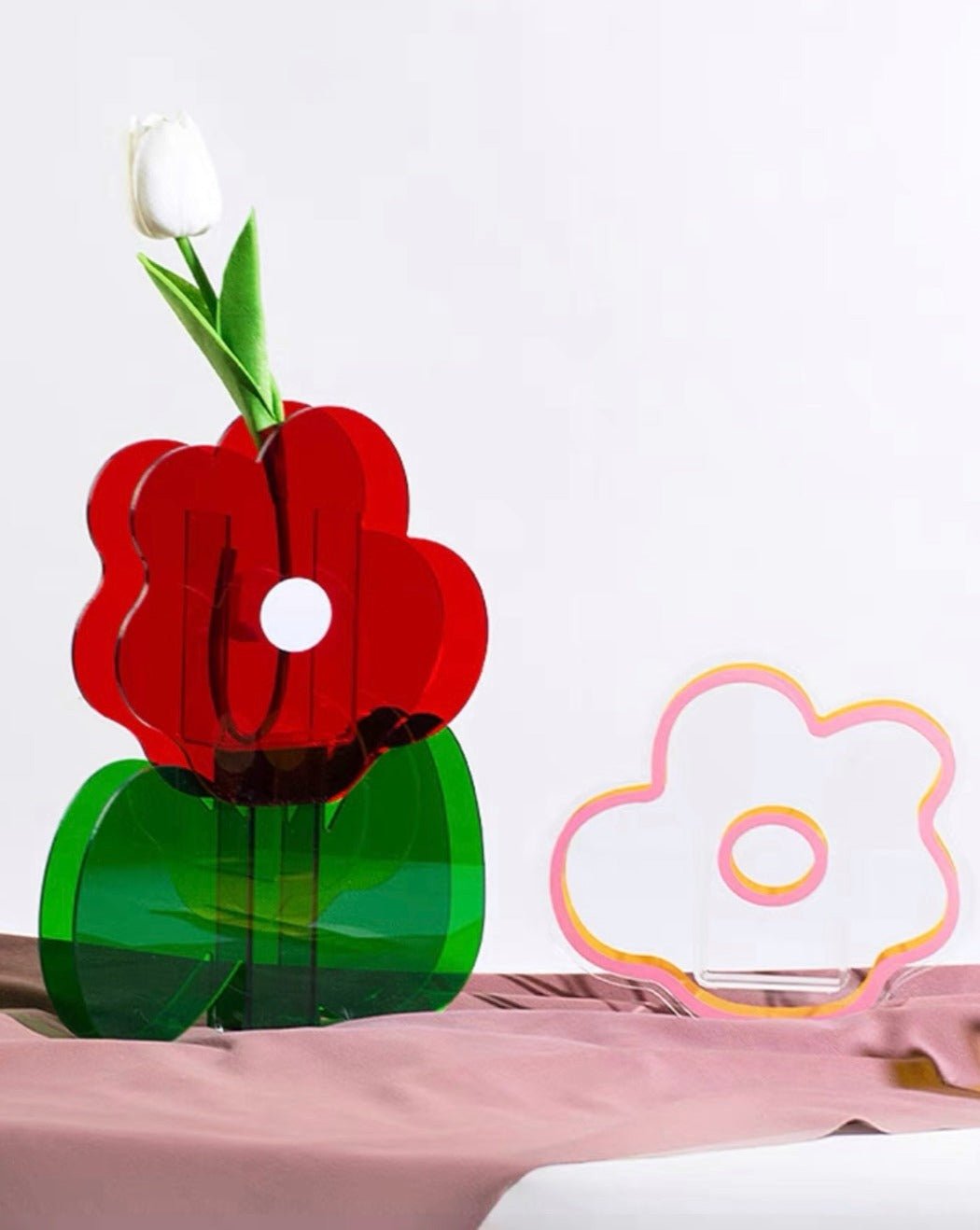 A modern creative acrylic decorative flower vase with a unique shape and floral motif, perfect for home decor.