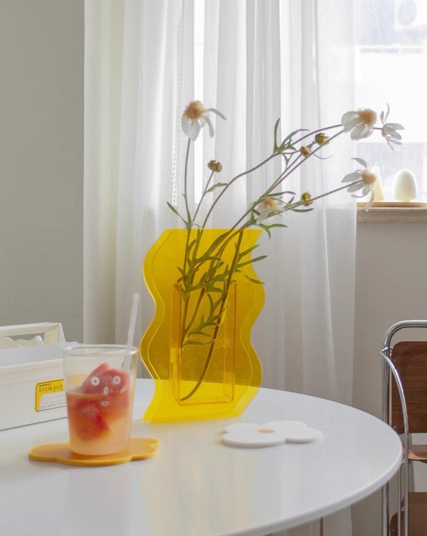 A modern creative acrylic decorative flower vase with a unique shape and floral motif, perfect for home decor.