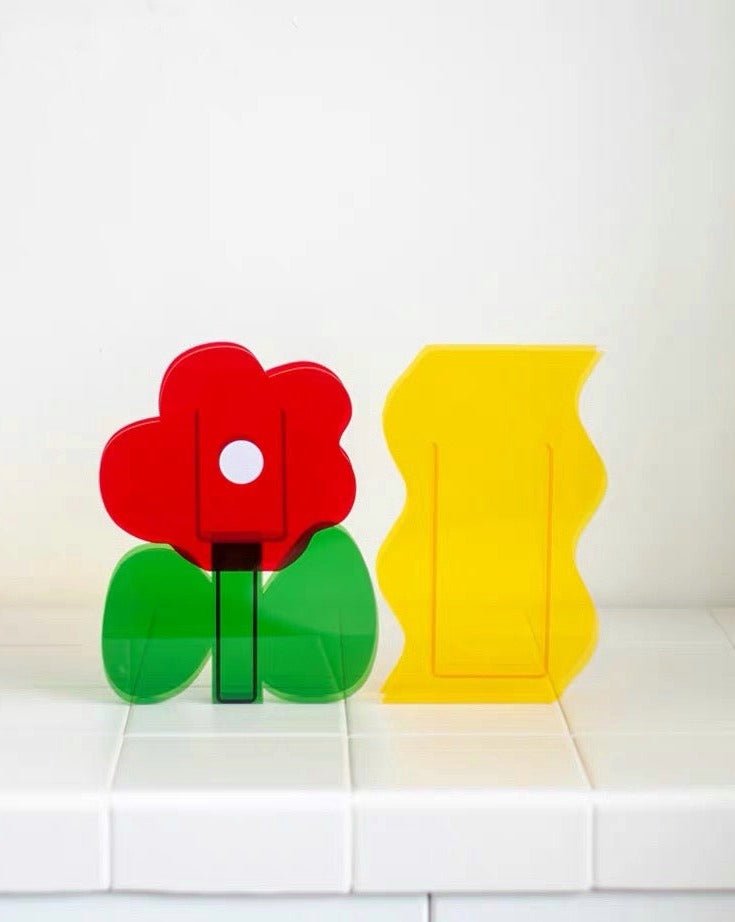 A modern creative acrylic decorative flower vase with a unique shape and floral motif, perfect for home decor.