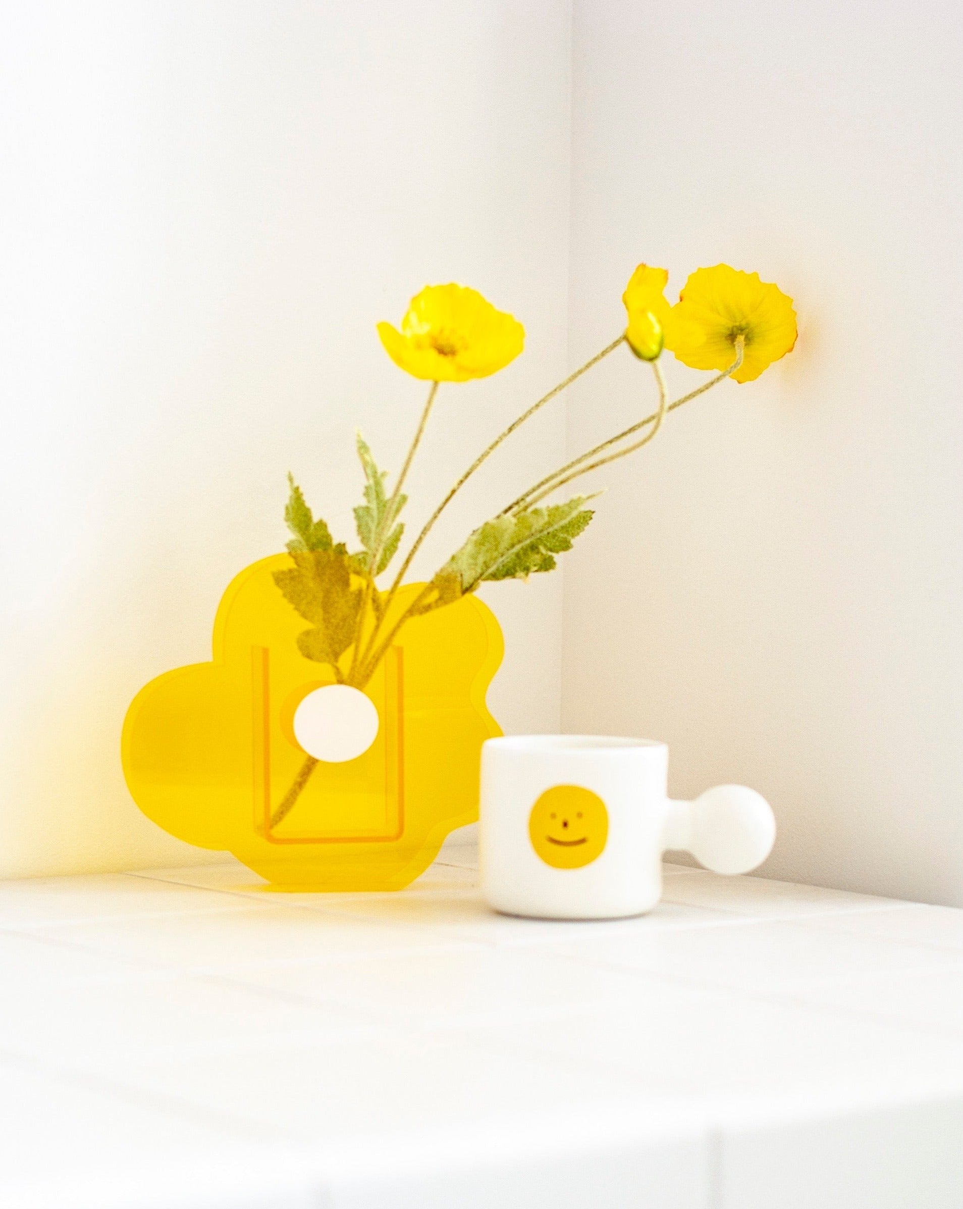 A modern creative acrylic decorative flower vase with a unique shape and floral motif, perfect for home decor.