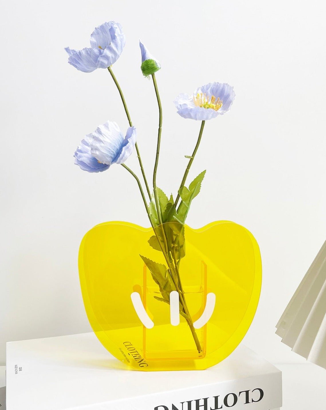 A modern creative acrylic decorative flower vase with a unique shape and floral motif, perfect for home decor.