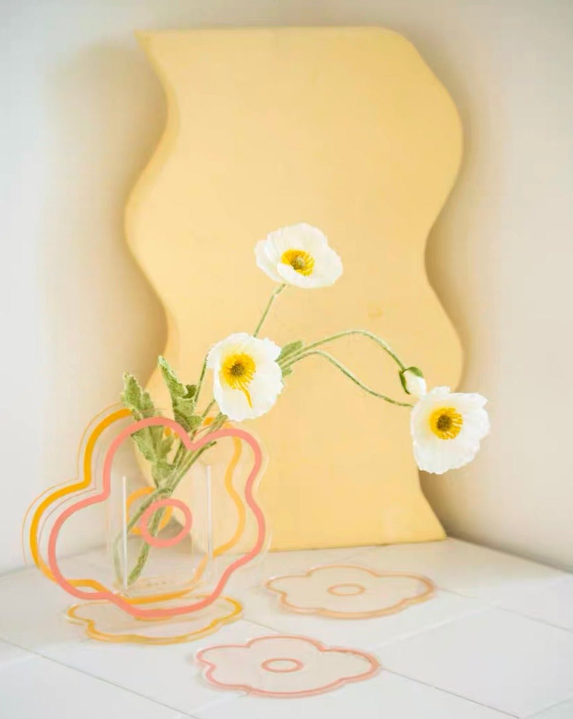 A modern creative acrylic decorative flower vase with a unique shape and floral motif, perfect for home decor.