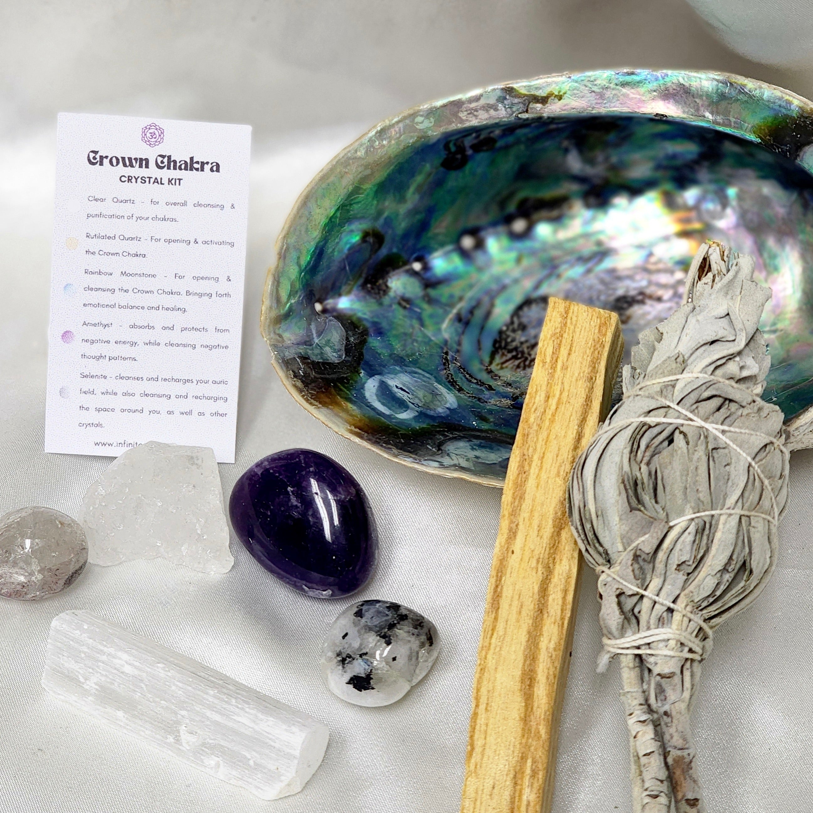 Crown Chakra Smudge Kit featuring sage smudge stick, Palo Santo, abalone shell, and assorted healing crystals for chakra alignment.